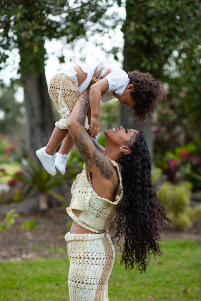 Mom holds her son up above her