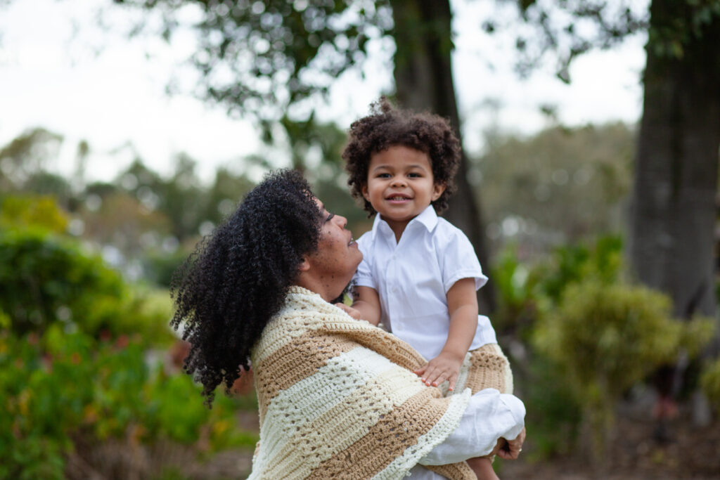 Grandma holds grandson and smiles at him