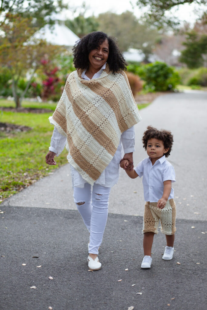 Grandma and holds young grandson's hand while walking