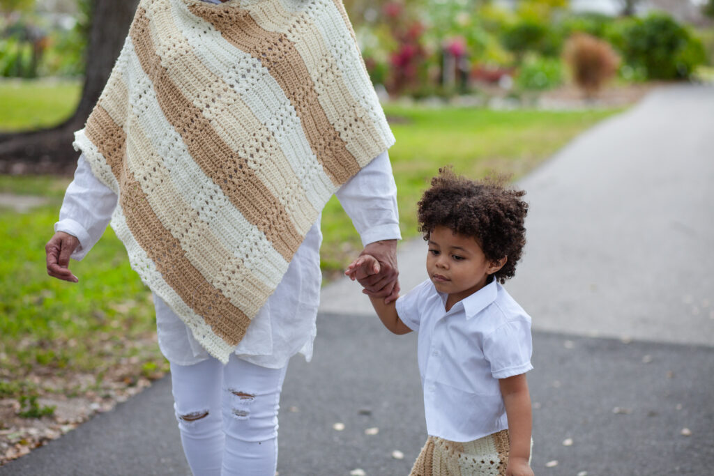 Photo is close on young boy holding his grandma's hand