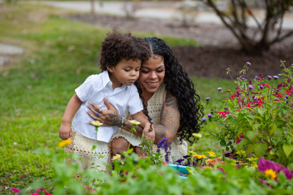 Mom and son look at a flower bed together