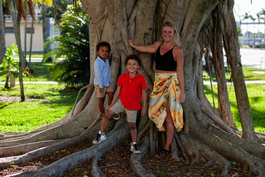 Family poses in front of banyan tree