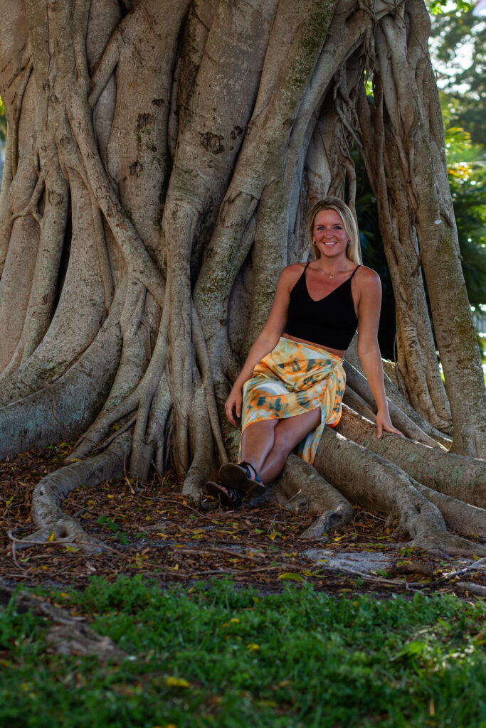 Woman seated on tree