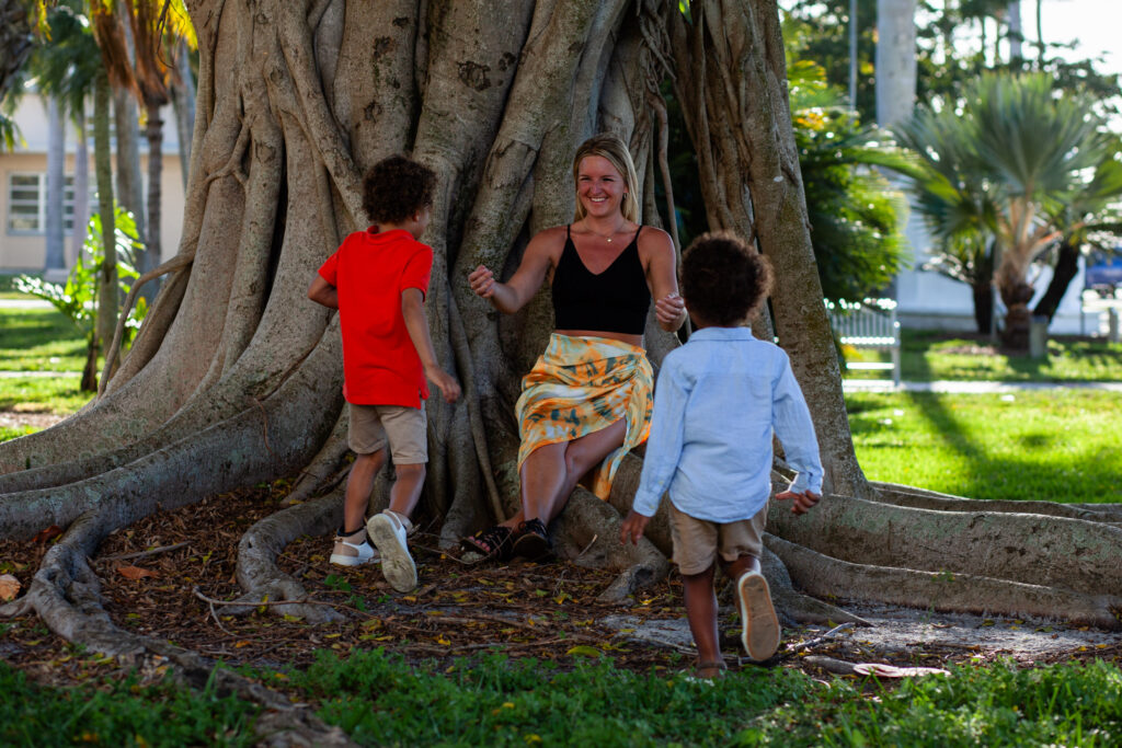 Two sons run to hug their mom