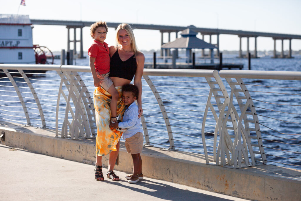 Mom and two sons pose by river