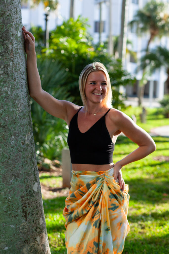 Woman poses against a tree