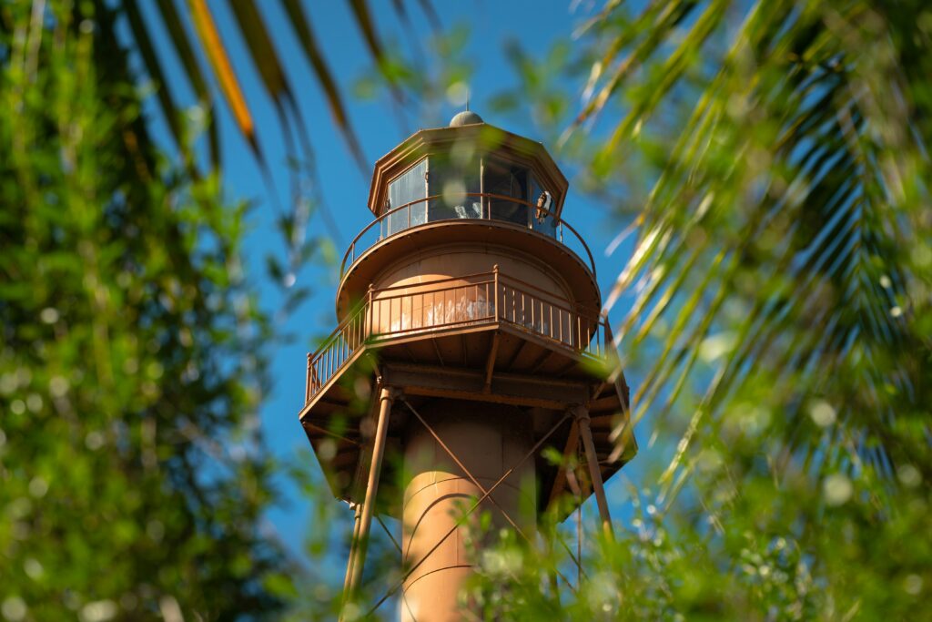 The top of the Sanibel Lighthouse seen through greenery