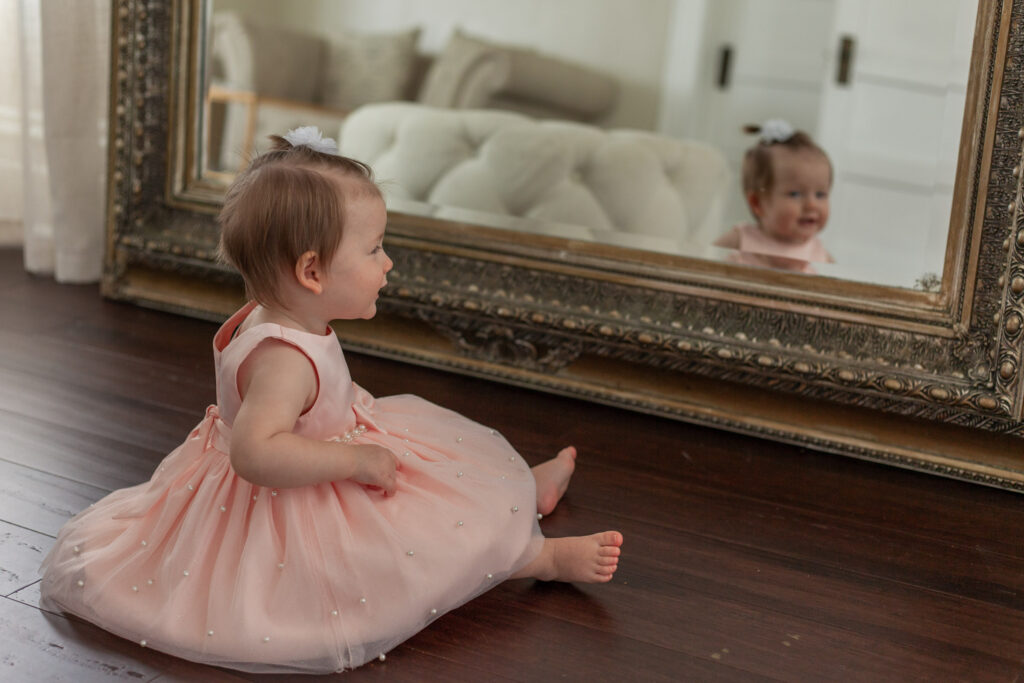 First birthday milestone photo with mirror