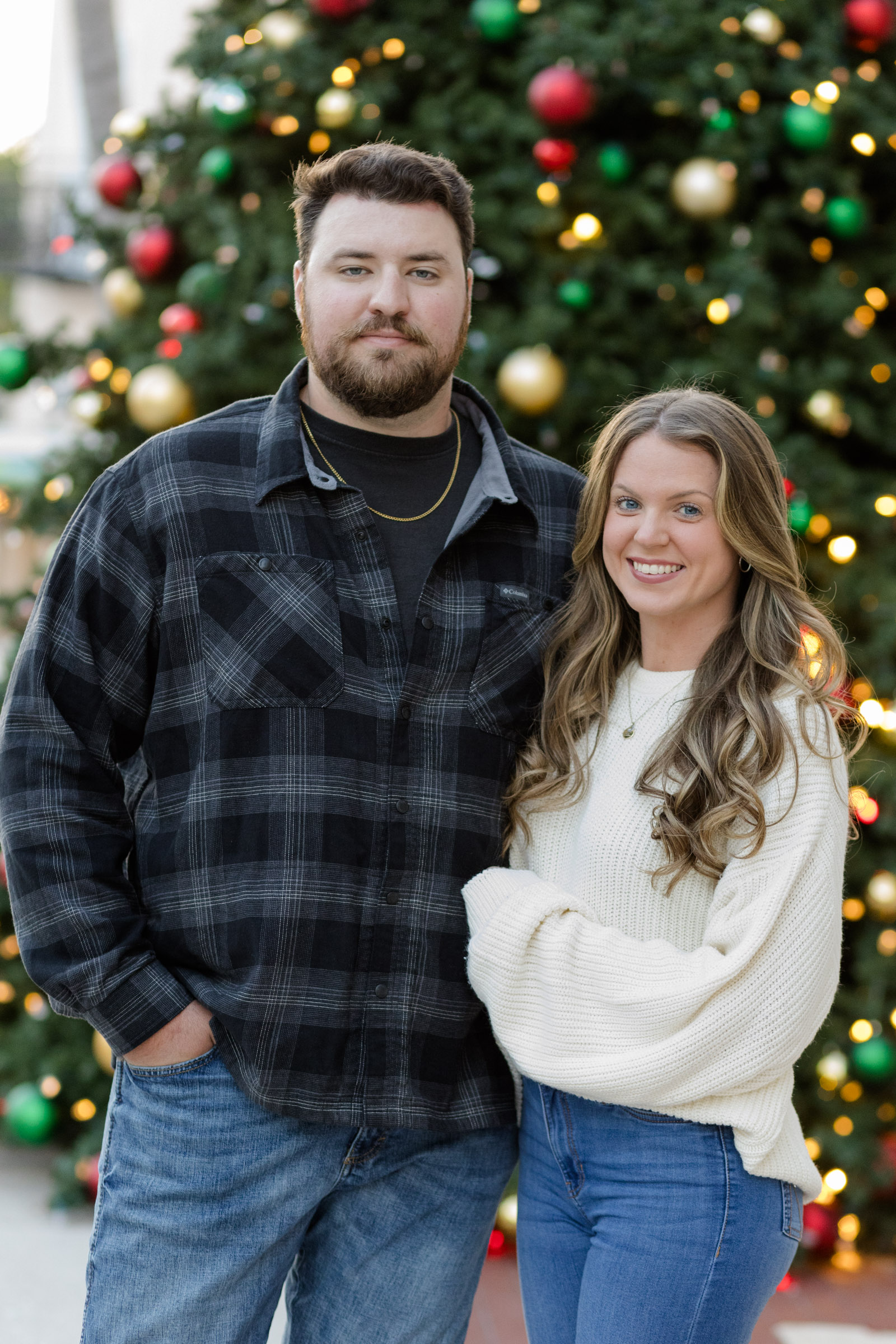 Couple in front of Christmas tree in Downtown Fort Myers