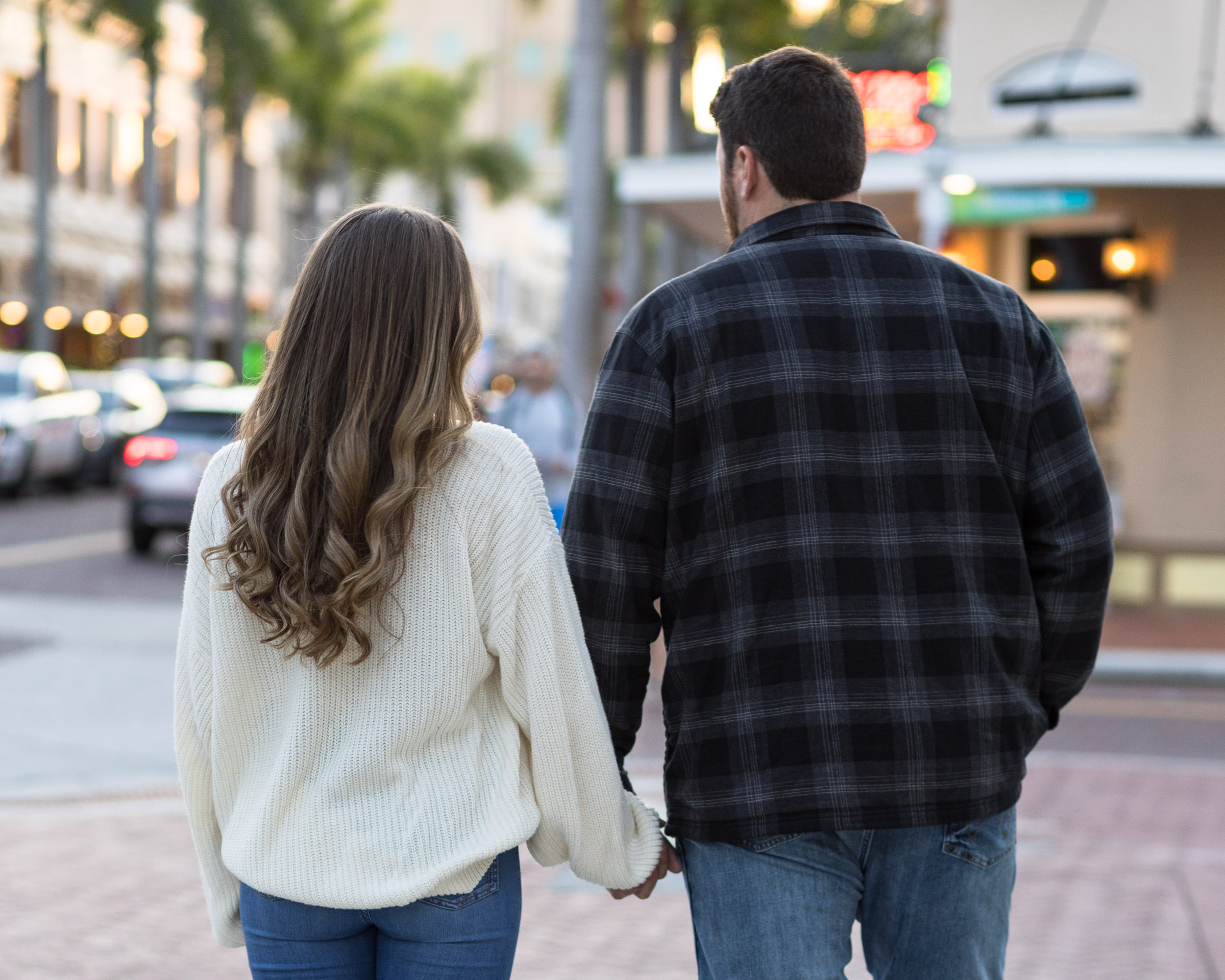 Couple walks away holding hands