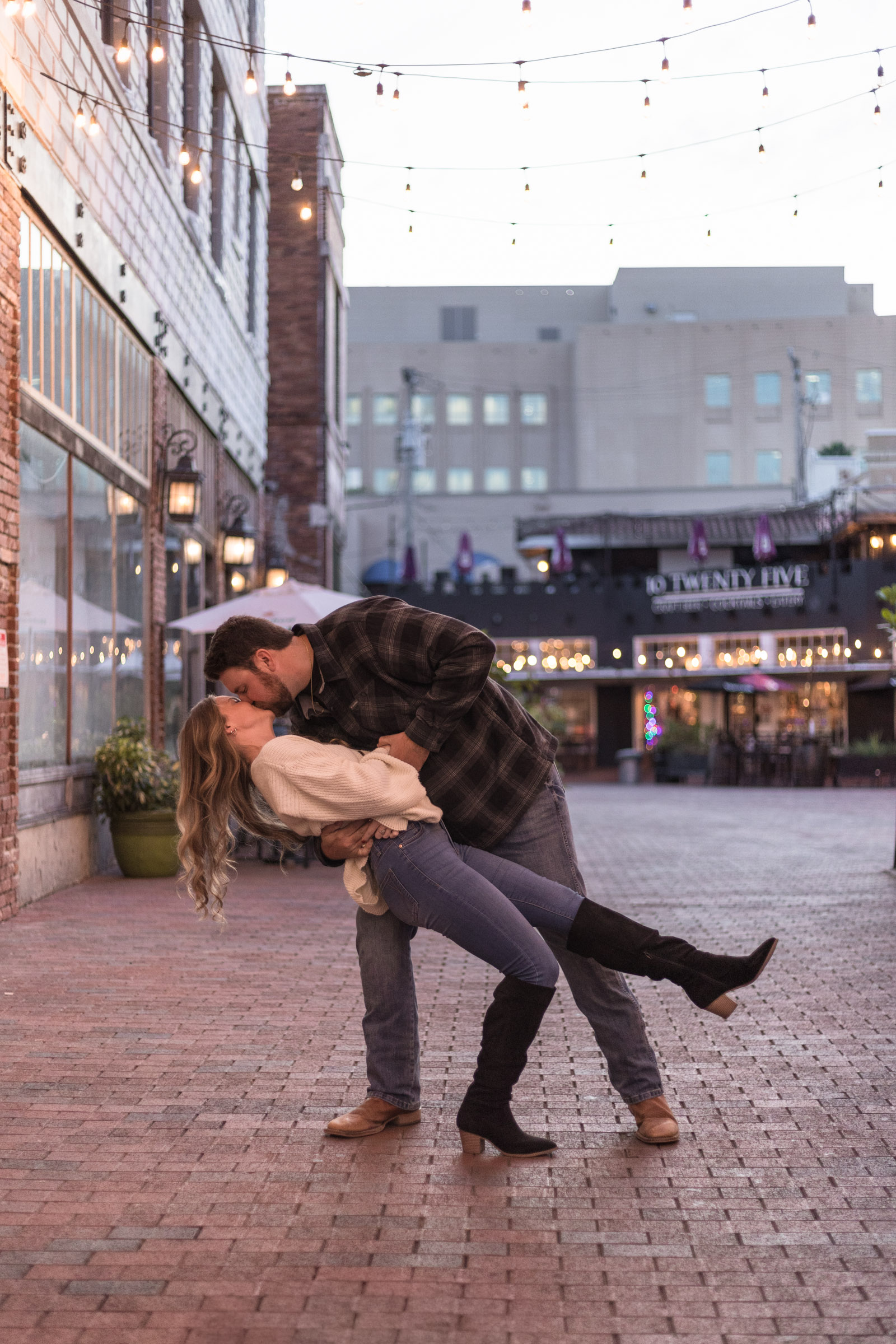 Man dips and kisses his girlfriend as they dance