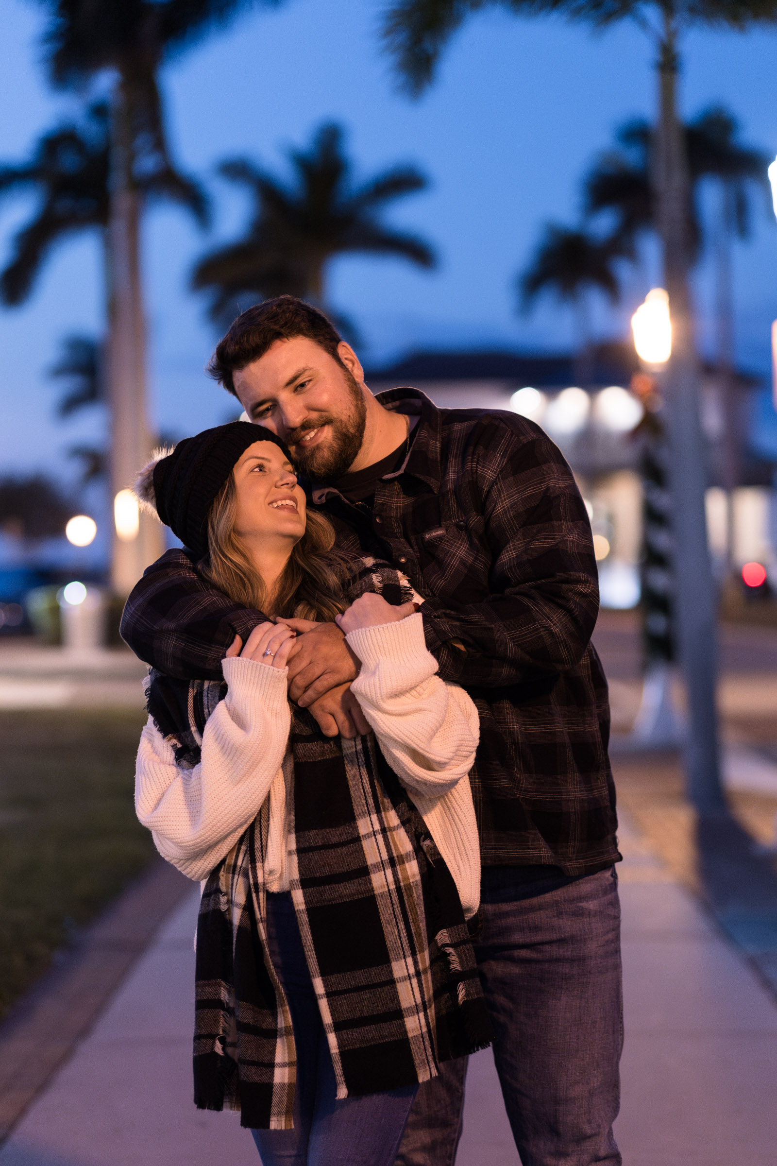 Couple hugs with blue hour skies in background
