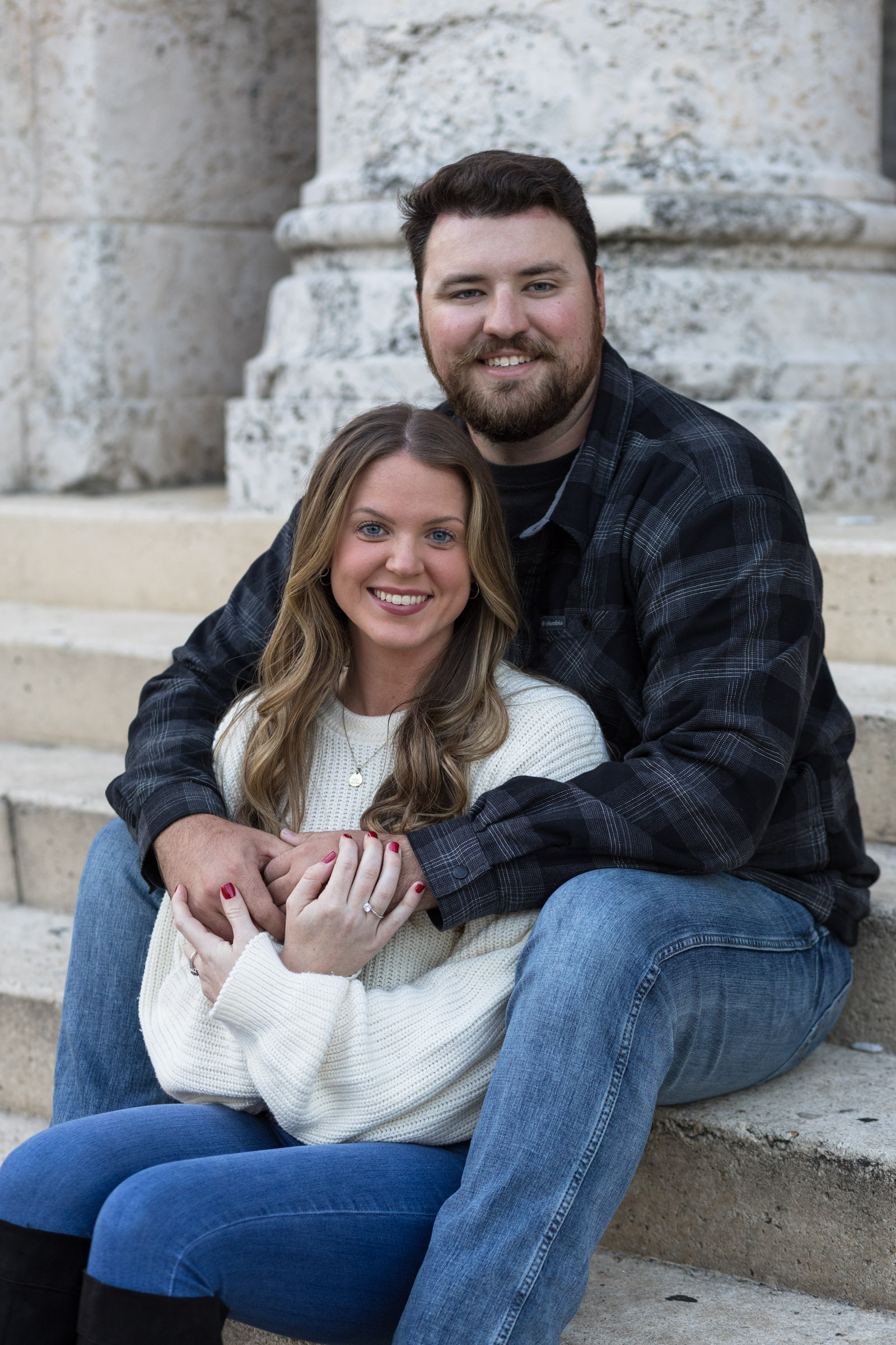 Man with his girlfriend sit on staircase for a photo