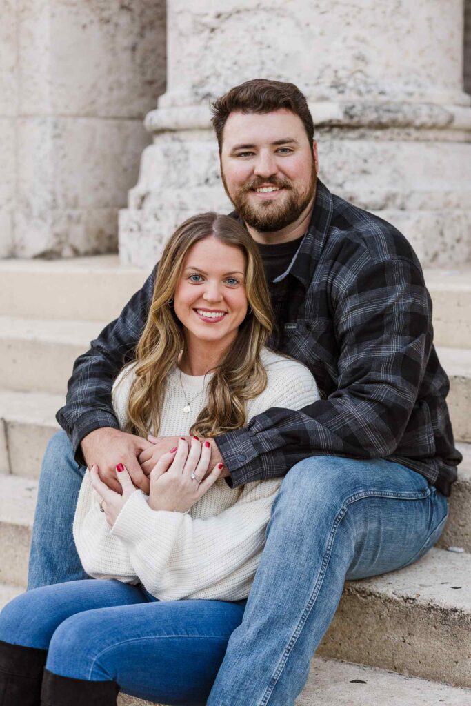 Couple poses on the steps of the Sidney and Berne Davis Art Center