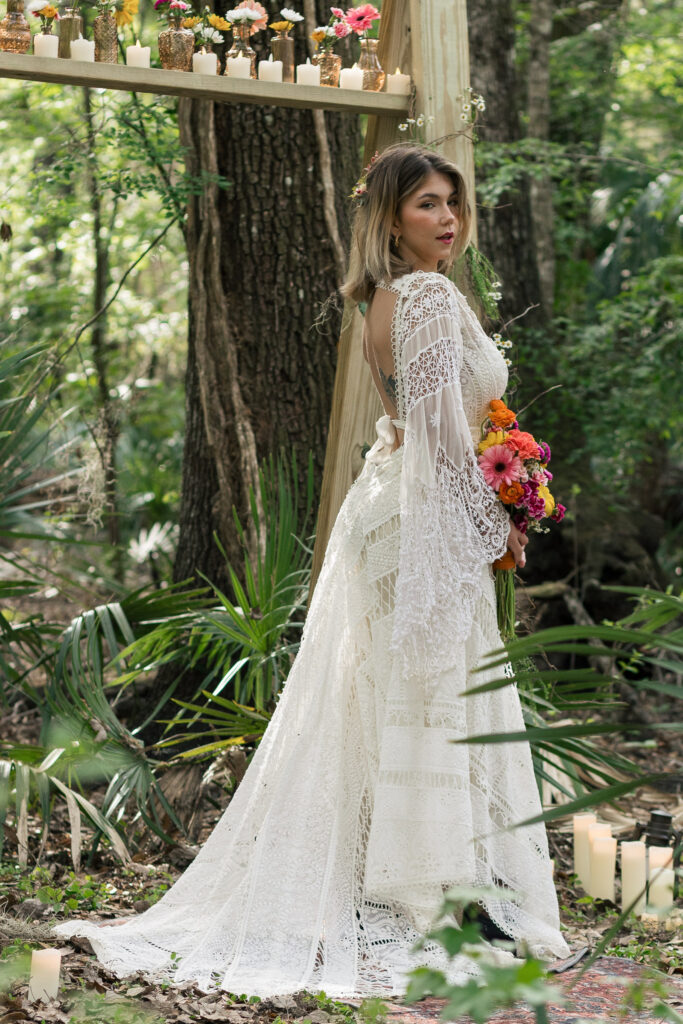 Bride holding her bouquet with her train out behind her