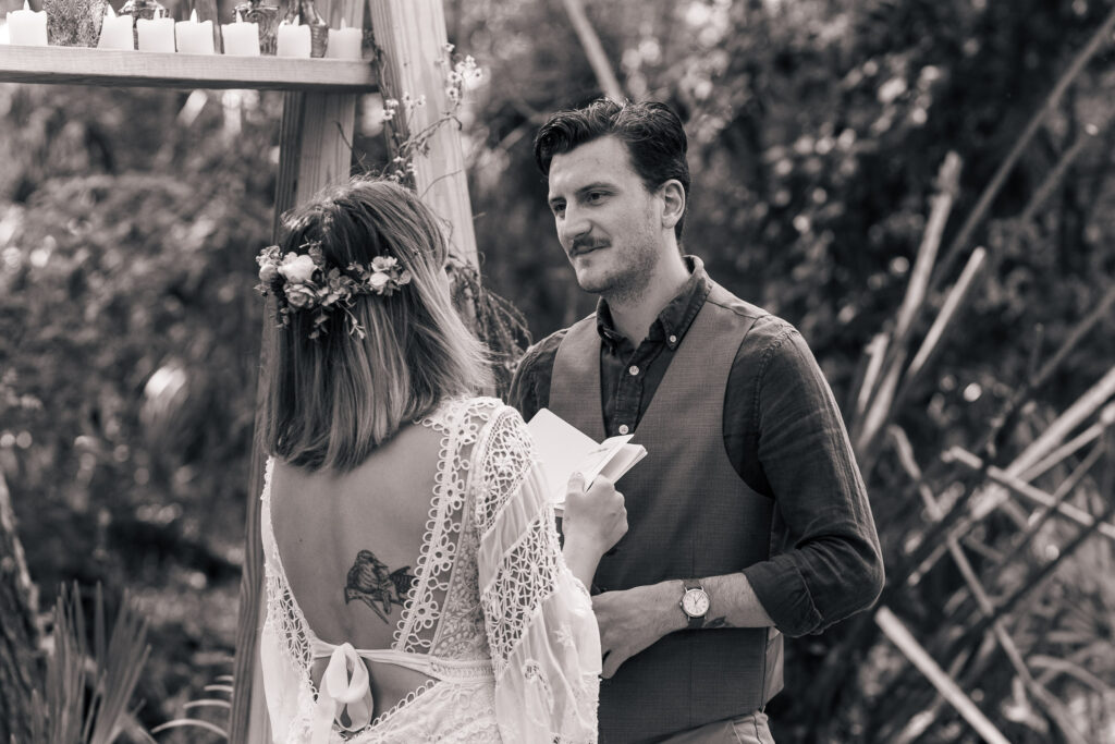 Black and white image of bride reciting vows to her groom