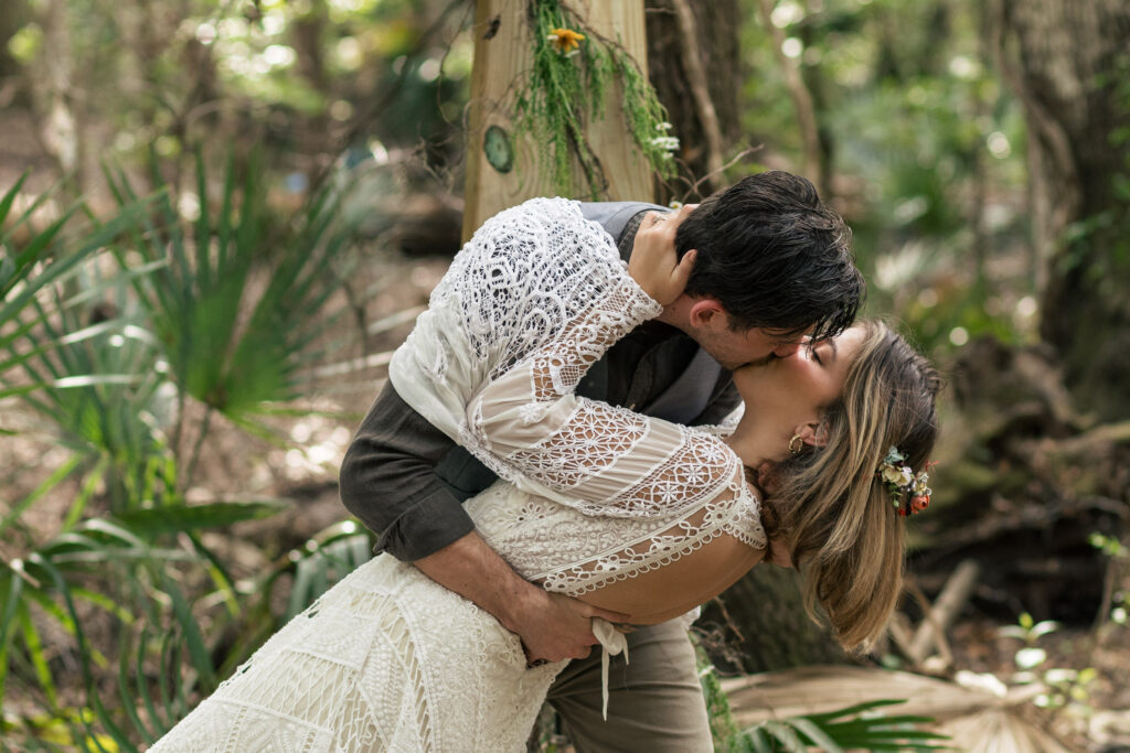 Groom dips his bride for their first kiss as husband and wife