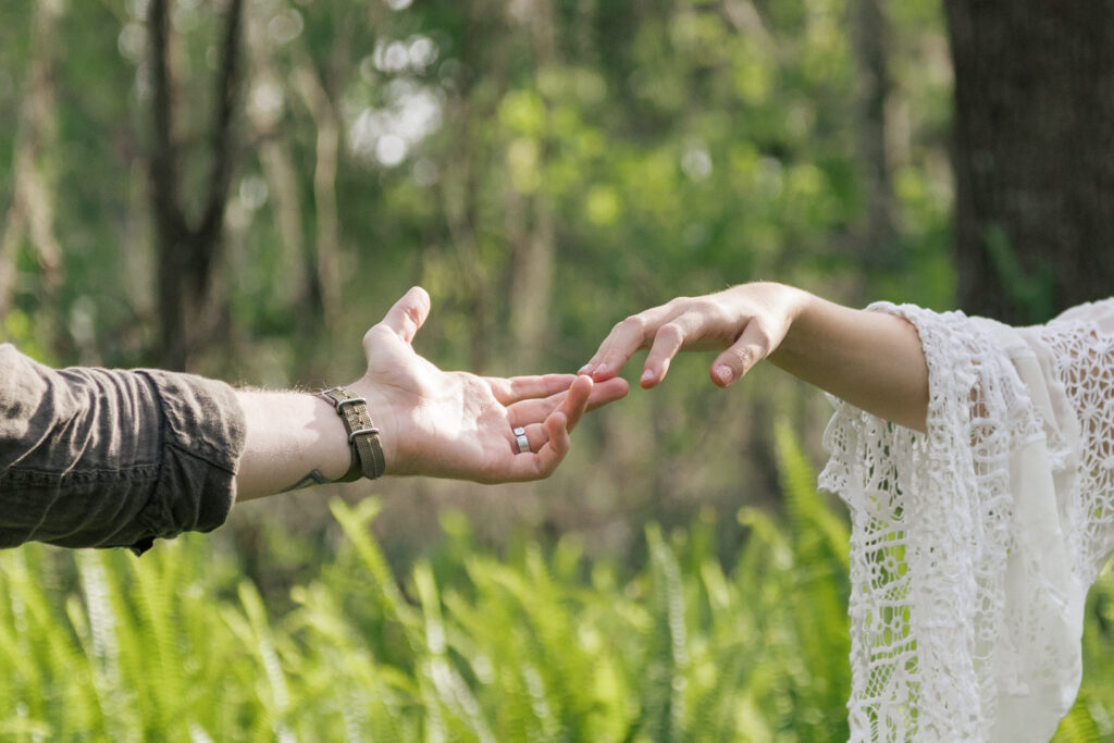 Bride and groom's hands in the creation of Adam pose