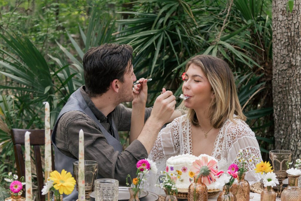 Bride and groom feed each other a bite of their elopement cake