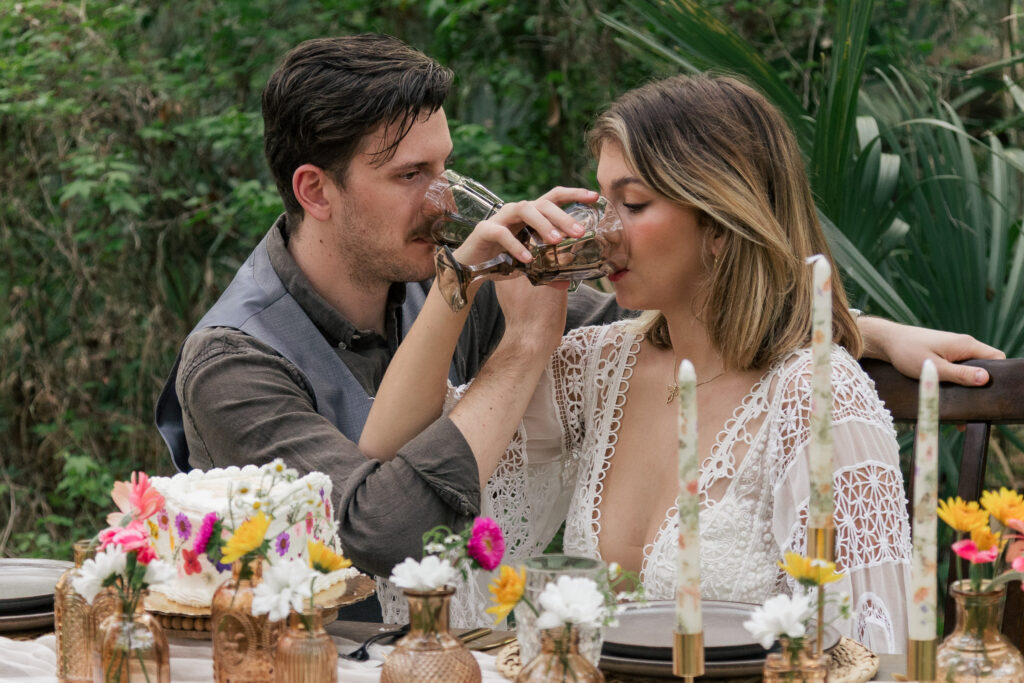 Bride and groom drink a toast with their arms interlocked