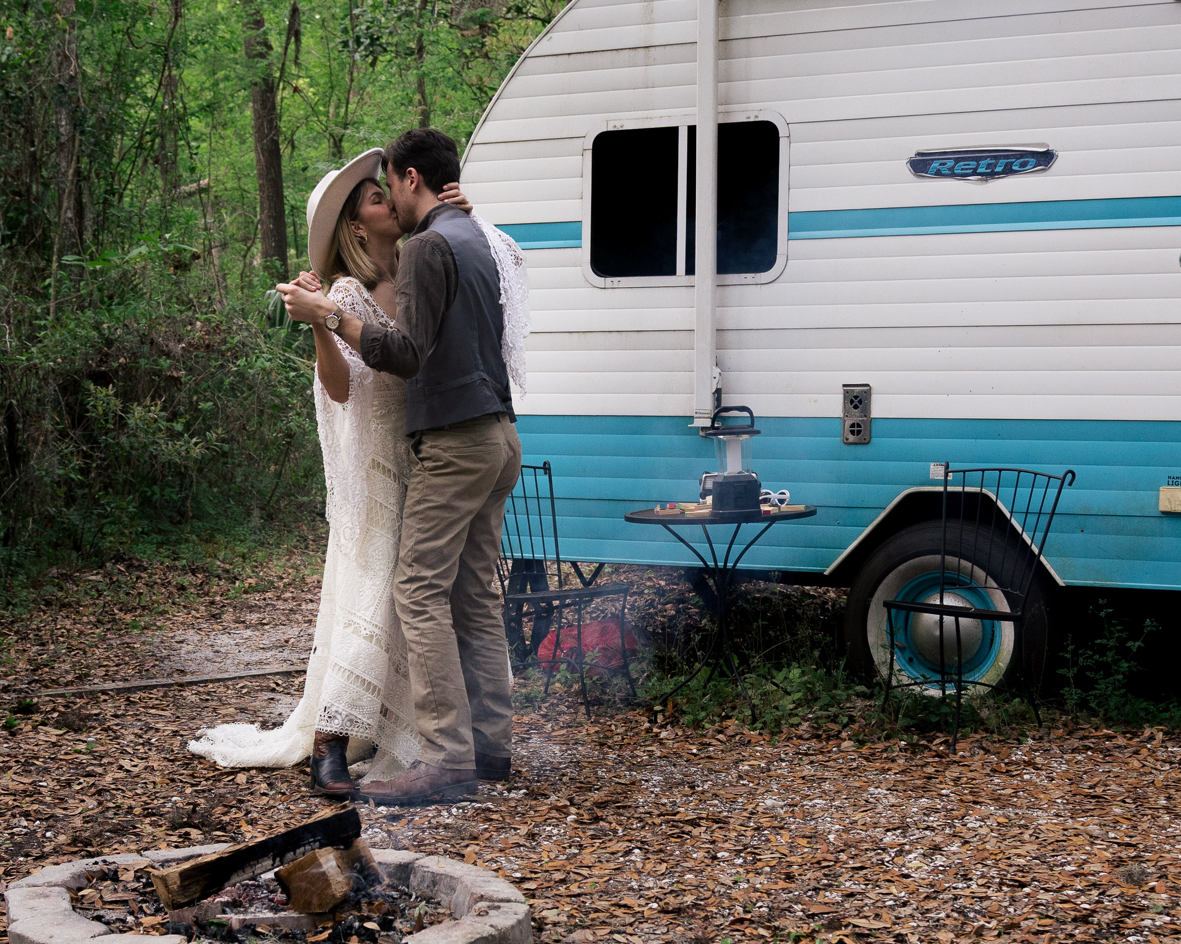 Couple kisses during their first dance at their campervan airbnb elopement