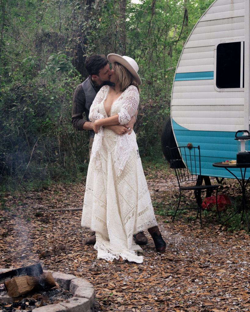 Bride and husband kiss during their first dance at their camper airbnb elopement
