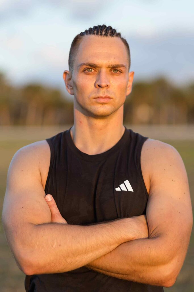 Headshot of fit young man with muscular arms