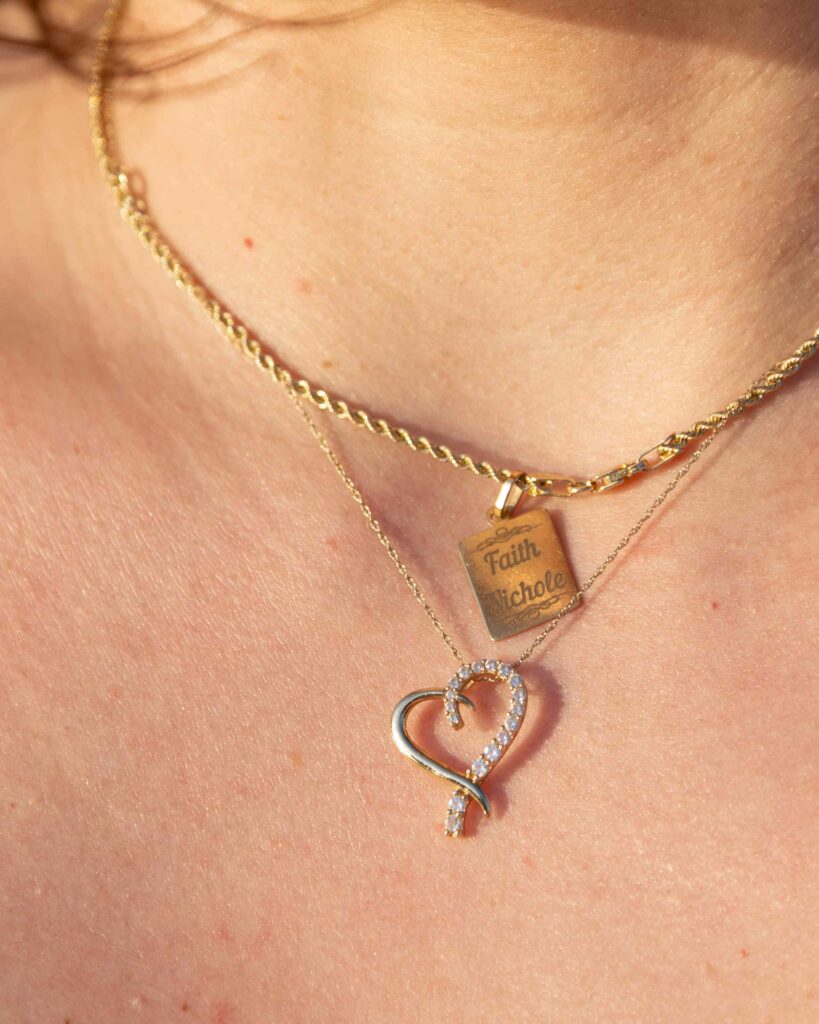Closeup of a mom's necklace with her daughter name on it