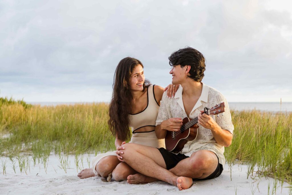 Man plays ukulele for his new fiancee on the beach