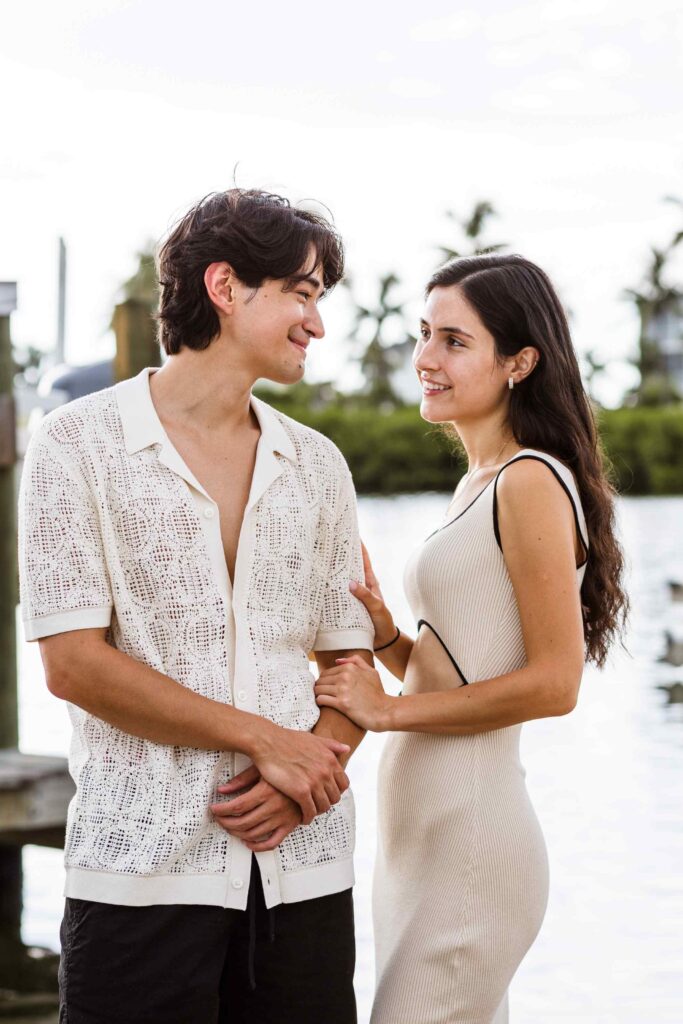 Couple smiling at each other at boat marina