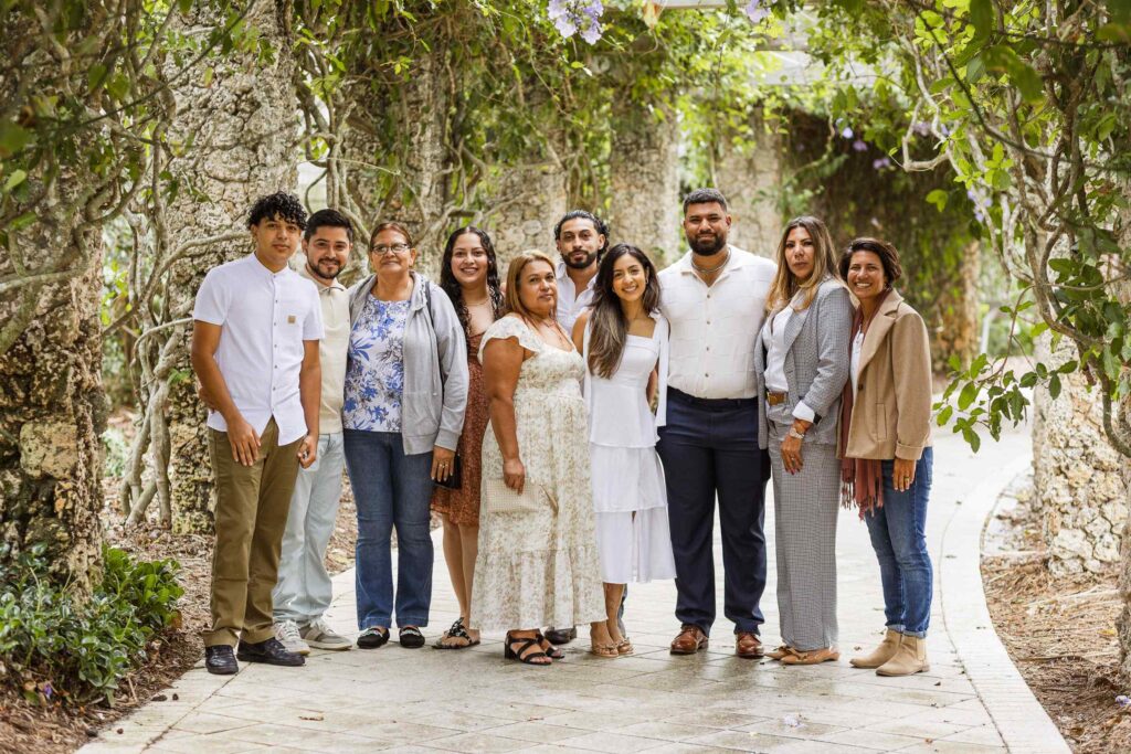 Family of 10 people pose in the flower tunnel at the Naples Botanical Garden