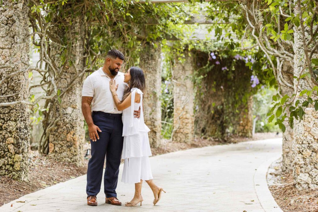 Couple poses in the flower tunnel at the Naples Botanical Garden