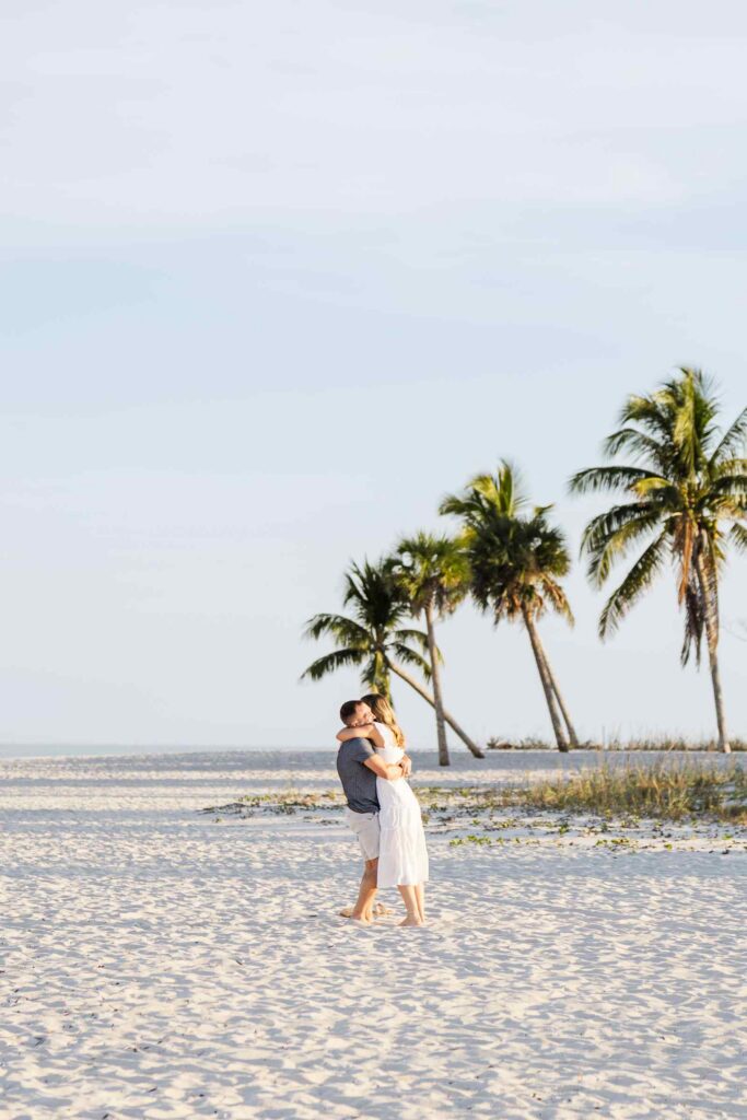 Couple hugs after proposal at the Sanibel Lighthouse Beach