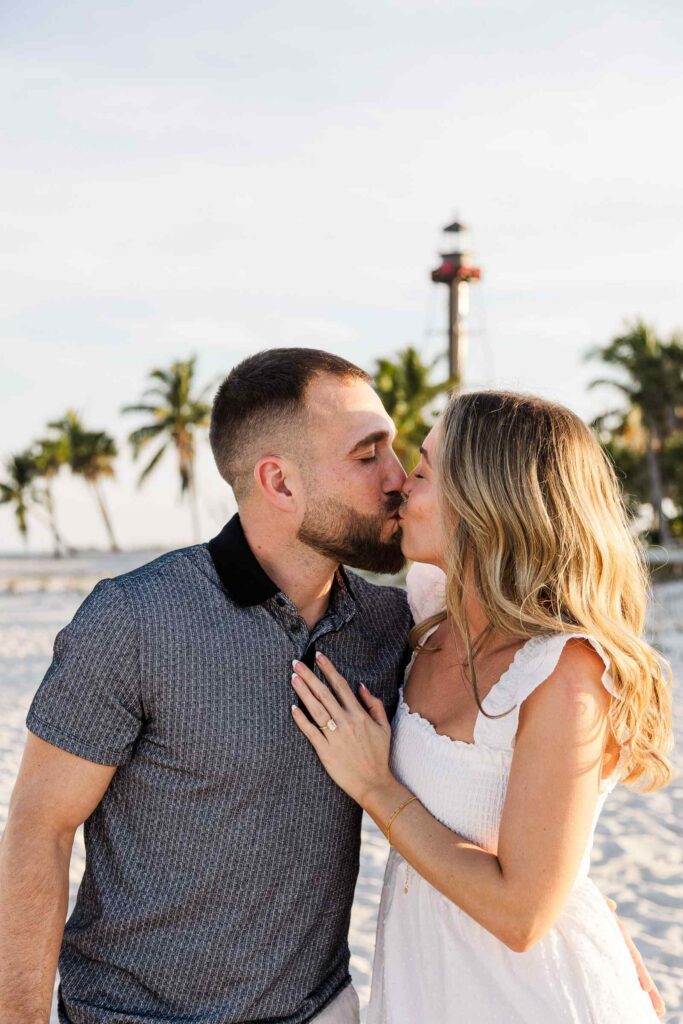 Couple kisses in front of the Sanibel Lighthouse
