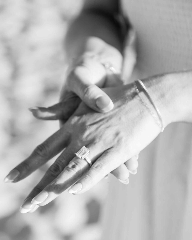 Black and white image of new engagement ring on woman's hand