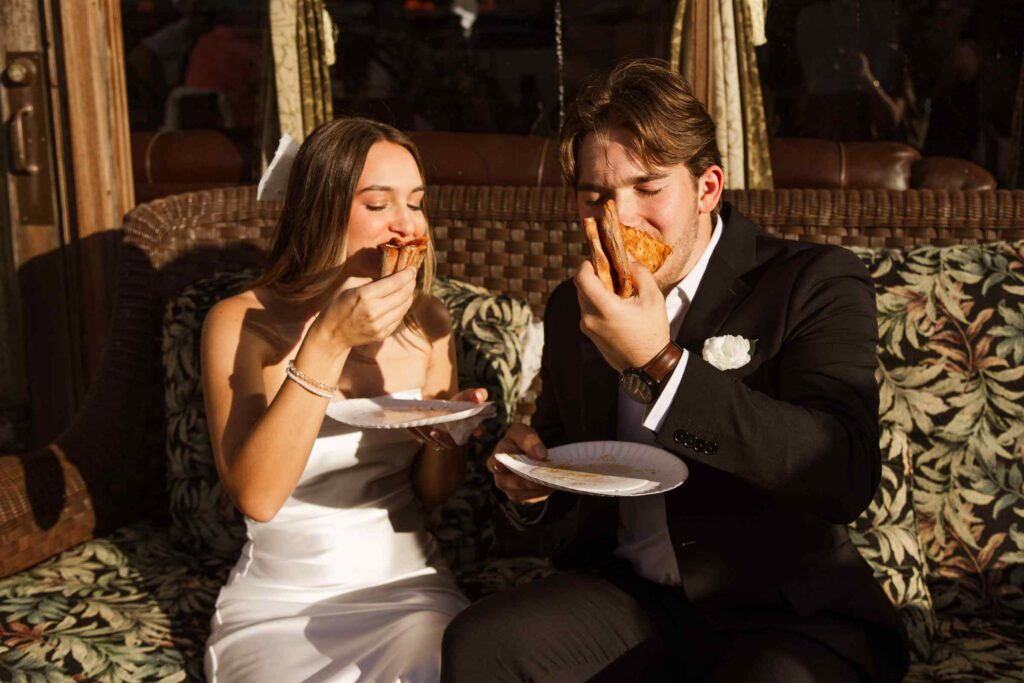 Bride and groom eat pizza together