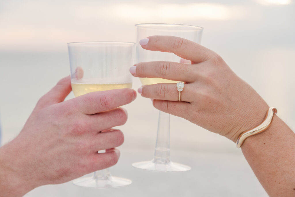 Couple toasts champagne on Wiggins Pass Beach