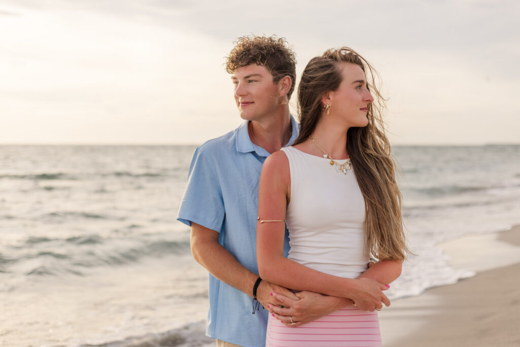 Couple looks off different directions on the beach