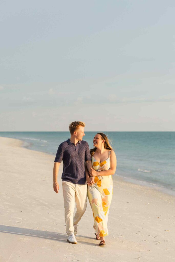 Couple walking on the beach in the sunset light