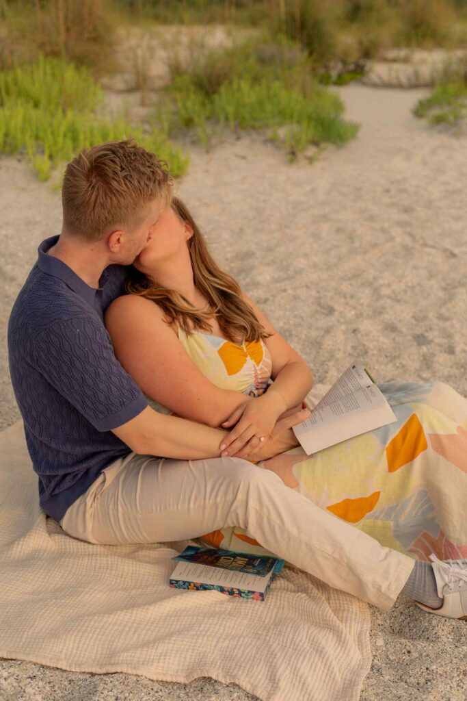 Couple reading together and kissing in between