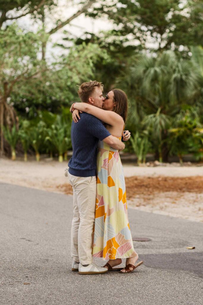 Couples kisses after proposal on Banyan Street in Boca Grande