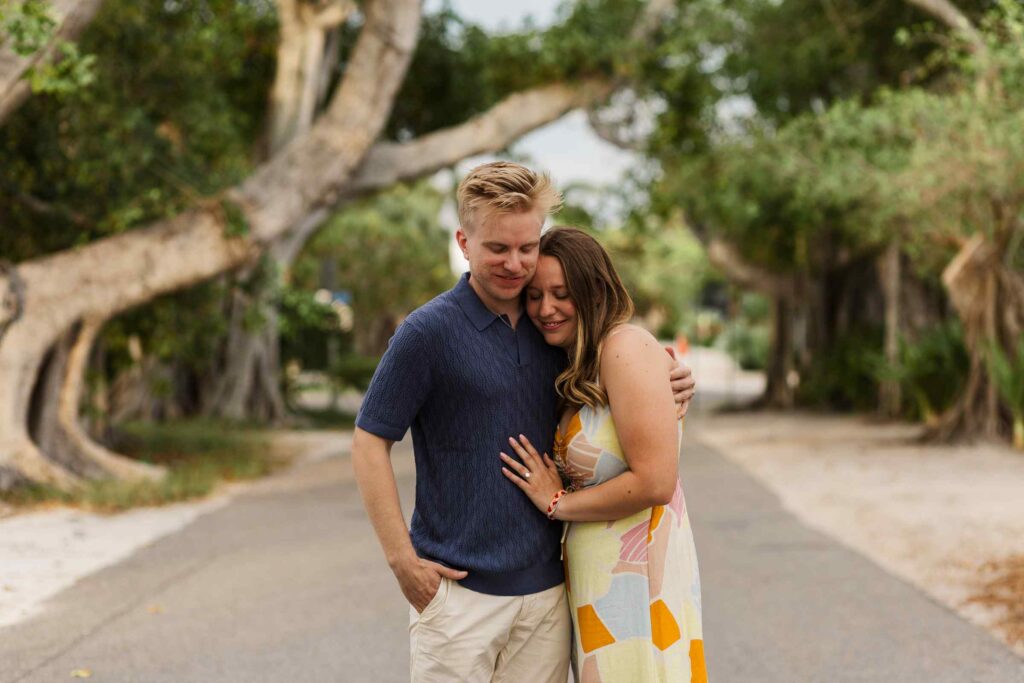 Couple hugs on Banyan Street in Boca Grande