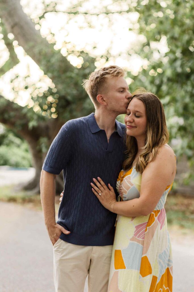 Man kisses fiancée on the temple